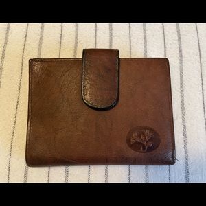 Buxton women’s top grain cowhide leather , floral embossed.